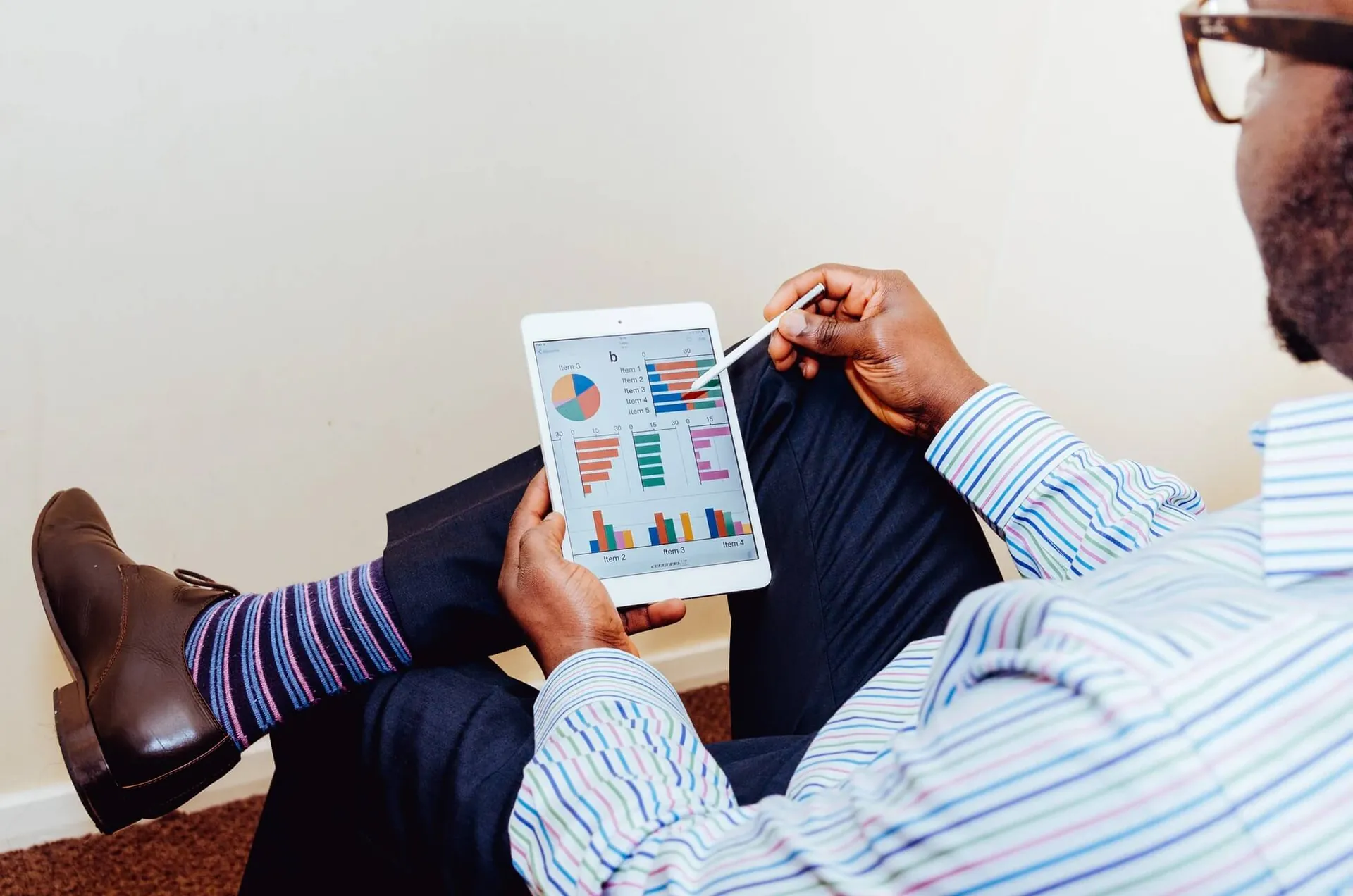 A business owner reviewing financial charts on a tablet